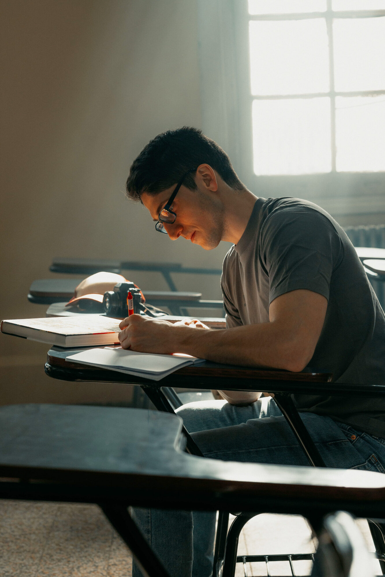 Boy taking notes in a classroom