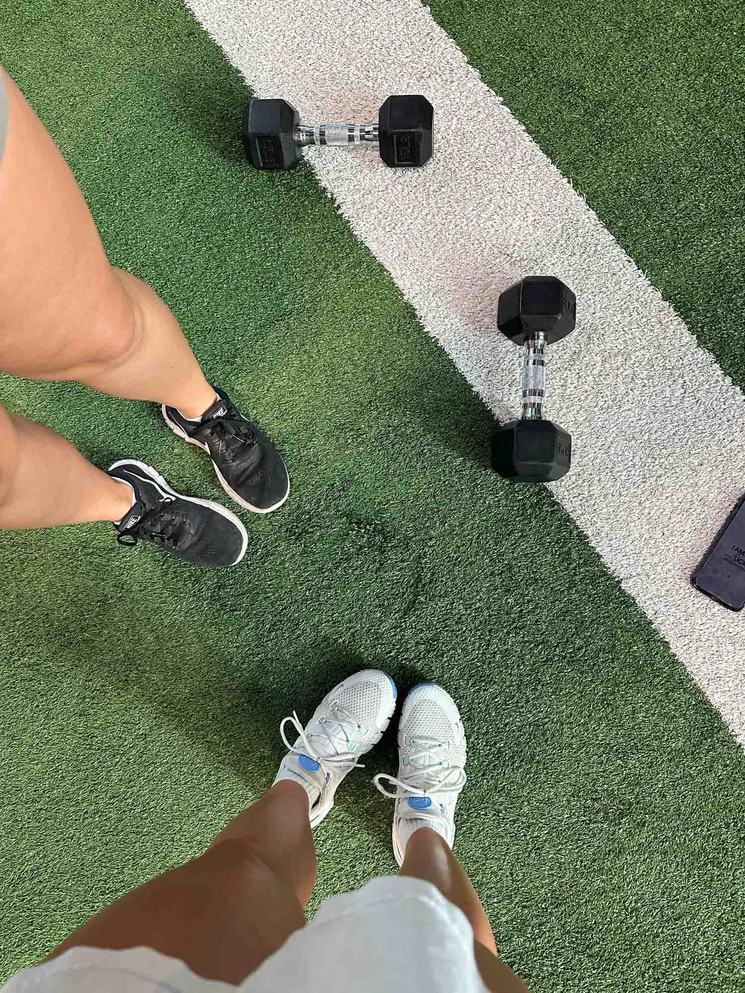 Woman lifting weights at the outdoor fitness station