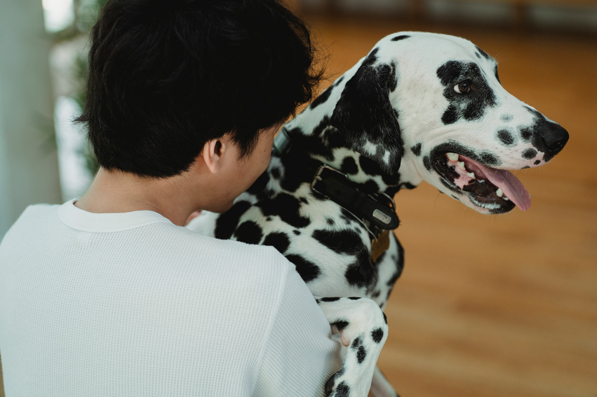 Young man snuggling his dog