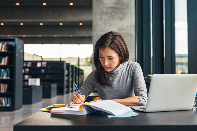 university student studying in library