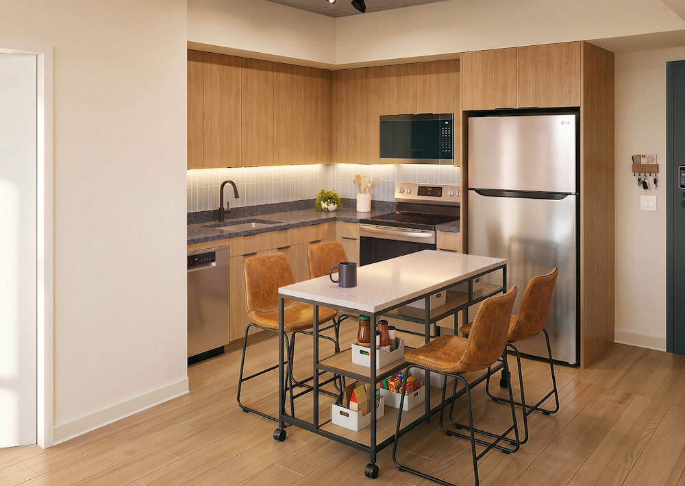 Compact modern apartment kitchen with natural wood cabinets stainless steel appliances and a mobile prep island with counter stools